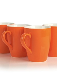 Porcelain mug set of four in citrusy orange.